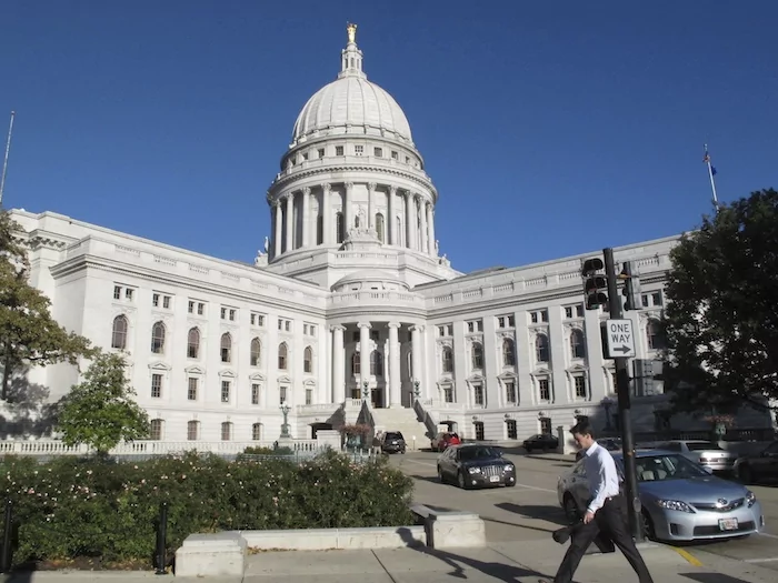 A man walks by the Wisconsin Capitol, Oct. 10, 2012, in Madison.