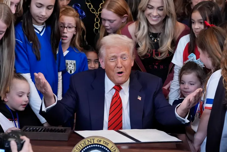 President Donald Trump signs an executive order barring transgender female athletes from competing in women's or girls' sporting events, in the East Room of the White House, Wednesday, Feb. 5, 2025, in Washington.