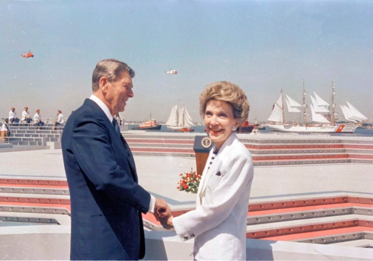 FILE - In this July 4, 1986 file photo, President Ronald Reagan and first lady Nancy Reagan hold hands as they watch the start of Op Sail from Governor's Island in New York Harbor.