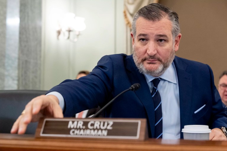 Ted Cruz sits at a desk