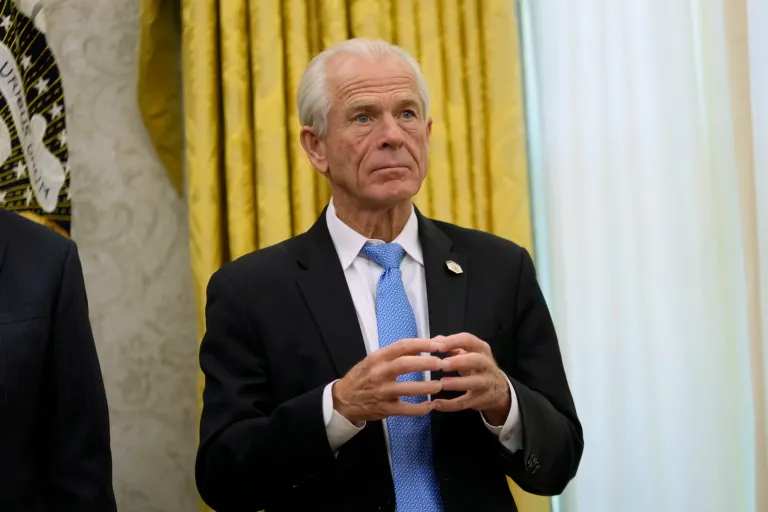 White House senior counselor for trade and manufacturing Peter Navarro listens as President Donald Trump speaks to reporters after signing an executive order in the Oval Office of the White House, Thursday, Feb. 13, 2025, in Washington.