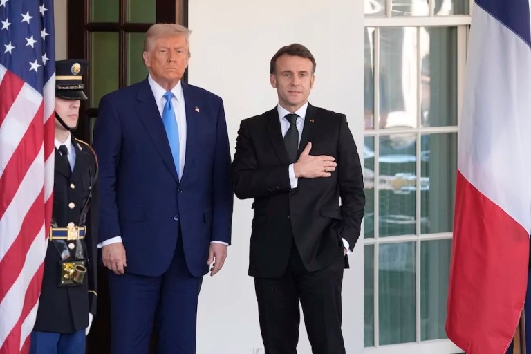 French President Emmanuel Macron responds to a reporter's question about Pope Francis as President Donald Trump listens before a news conference at the White House, Monday, Feb. 24, 2025, in Washington.