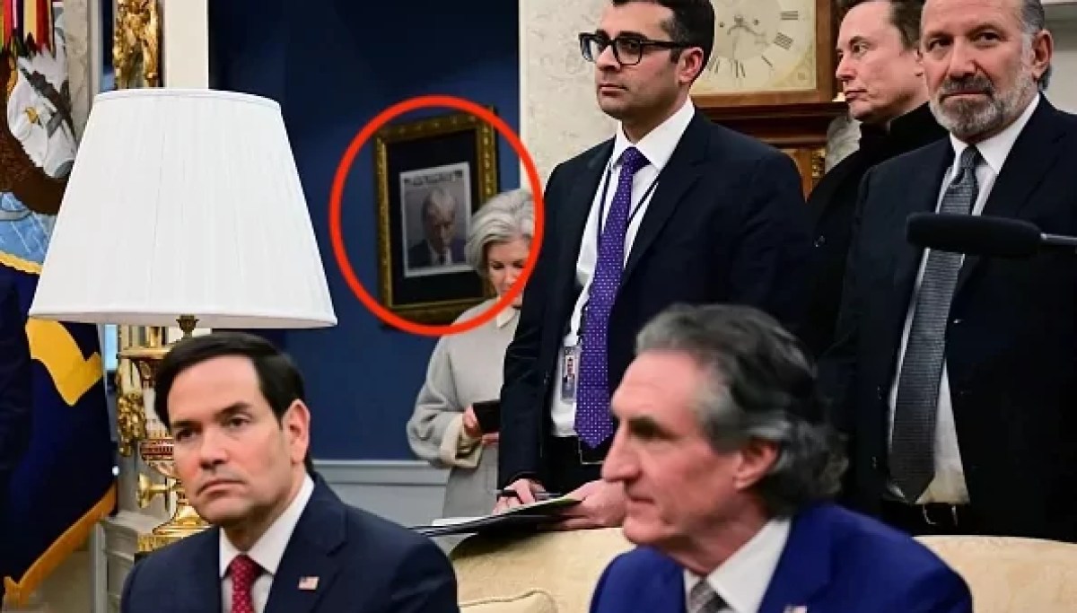 Trump's mug shot seen hanging up in a gold frame outside the Oval Office