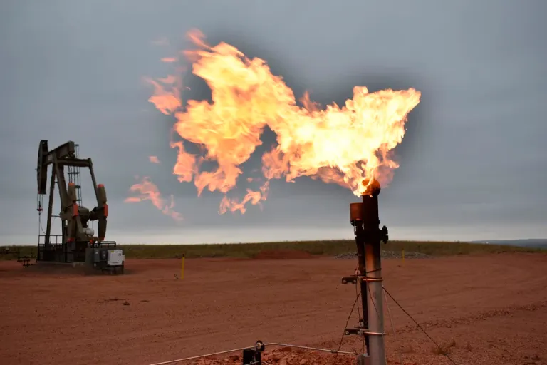 A flare burns natural gas at an oil well in Watford City, North Dakota, Aug. 26, 2021.