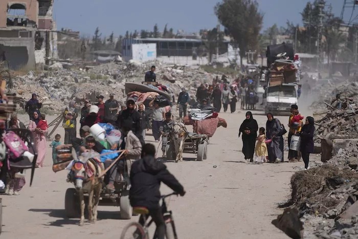 Displaced Palestinians, carrying their belongings traveling from Beit Hanoun to Jabaliya, a day after Israel's renewed offensive in the Gaza Strip, Wednesday, March 19, 2025.