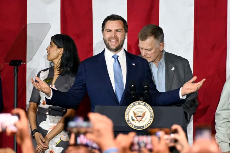 Vice President JD Vance, center, speaks at a rally about 