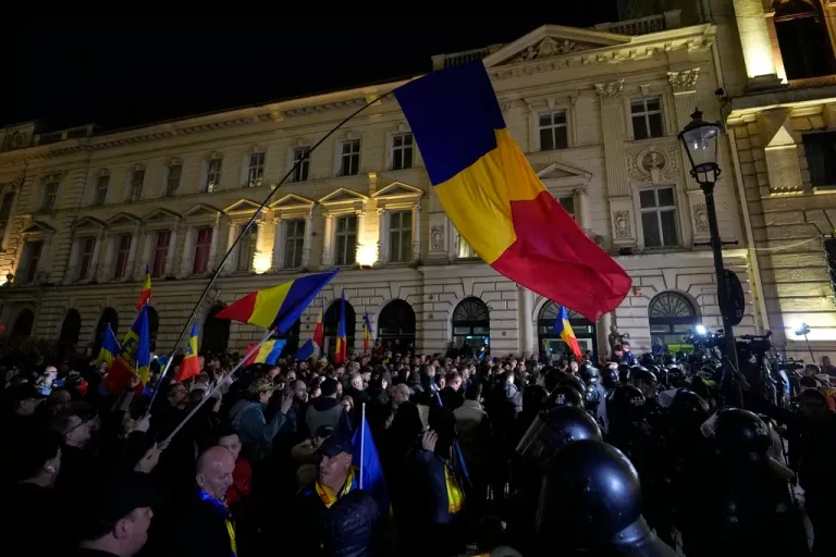 Supporters of Calin Georgescu react during a protest after Romania's electoral body rejected his candidacy in the presidential election rerun in Bucharest, Romania, Sunday, March 9, 2025.