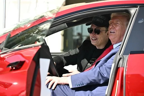 President Donald Trump and Tesla CEO Elon Musk speak to the press as they sit in a Tesla on the South Portico of the White House, March 11, 2025, in Washington, D.C.