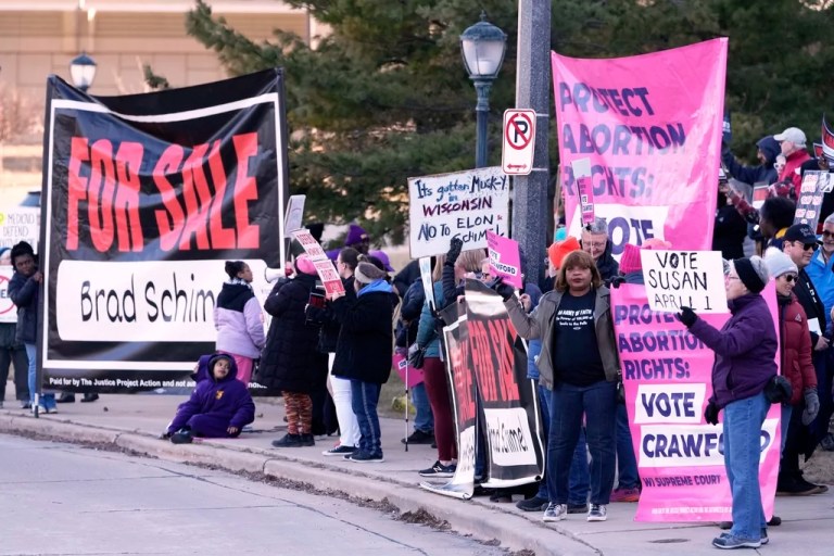 Protesters gather outside the Marquette Lubar Center before a Wisconsin Supreme Court debate between candidates Brad Schimel and Susan Crawford Wednesday, March 12, 2025, in Milwaukee.