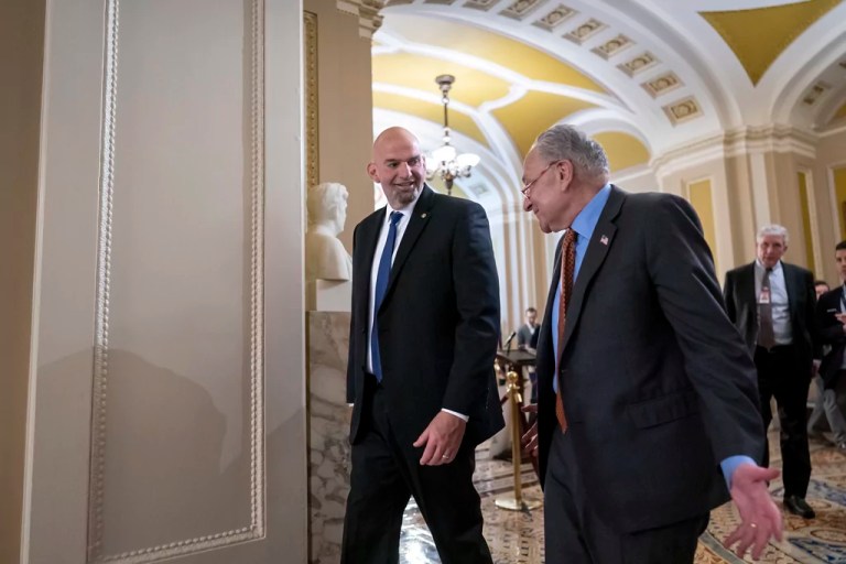 Sen. John Fetterman (D-PA), left, walks with Senate Majority Leader Chuck Schumer (D-NY) as they head to a Democratic lunch at the Capitol in Washington, Tuesday, April 18, 2023. This is Fetterman's first week back after being treated for clinical depression for six weeks.