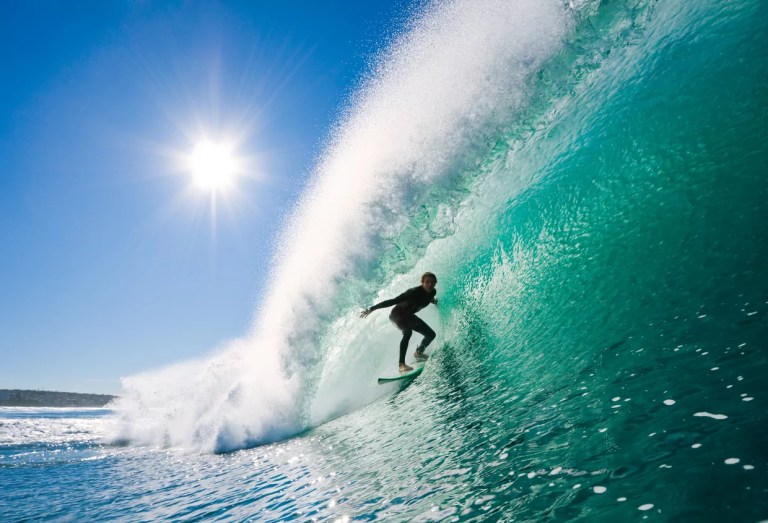 Surfer on perfect wave in the barrel.