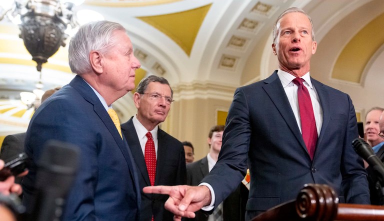 Senate Majority Leader John Thune (R-SD), right, points toward Sen. Lindsey Graham (R-SC) next to Sen. John Barrasso (R-WY) center, while speaking to reporters, Tuesday, Feb. 11, 2025, after a Senate policy luncheon on Capitol Hill in Washington.
