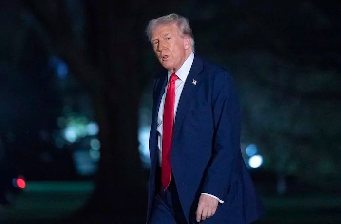 President Donald Trump talks to reporters as he walks on the South Lawn of the White House
