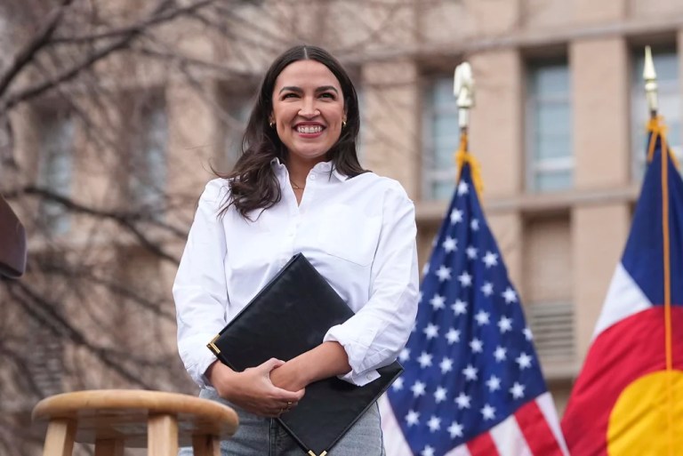 Rep. Alexandria Ocasio-Cortez, D-N.Y., smiles after speaking during a stop of their 