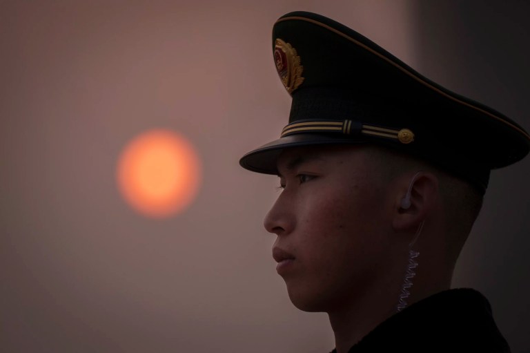 A Chinese paramilitary police officer stands guard near the Monument to the People's Heroes on Tiananmen Square before the closing session of the Chinese People's Political Consultative Conference in Beijing, Monday, March 10, 2025.