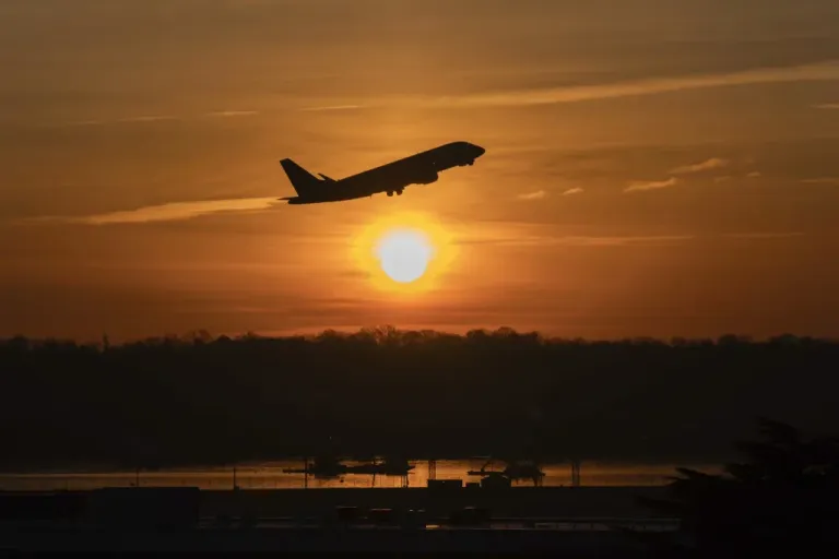 An airplane lifts off from Ronald Reagan Washington National Airport as the sun rises Monday, Feb. 3, 2025, in Arlington, Va.