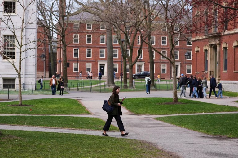 Pedestrians walk through Harvard Yard at Harvard University