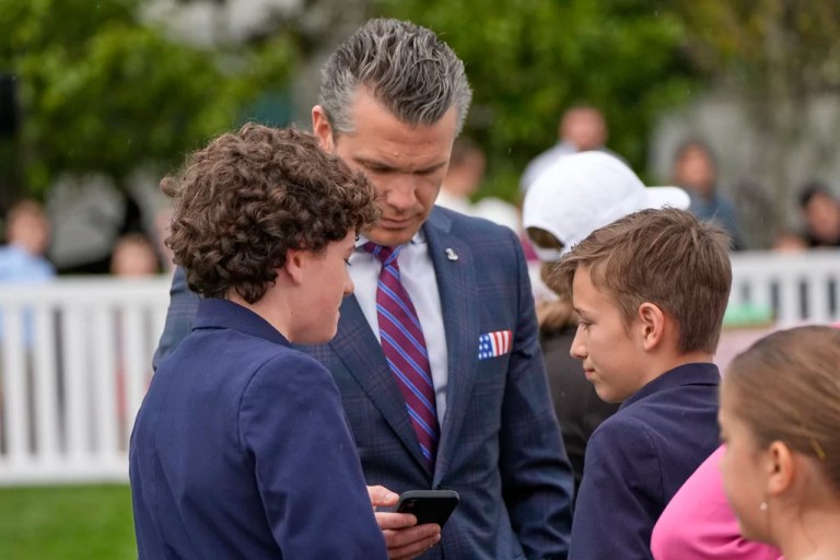 Defense Secretary Pete Hegseth looks at his phone on the South Lawn of the White House before President Donald Trump and first lady Melania Trump participate in the White House Easter Egg Roll Monday, April 21, 2025, in Washington.