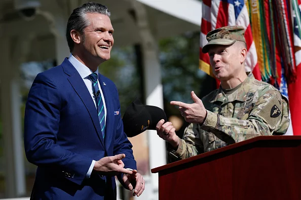 Secretary of Defense Pete Hegseth, left, jokes with Maj. Gen. David Hill, commandant of the Army War College, as he delivers remarks to students, faculty, and staff at the U.S. Army War College, April 23, 2025, in Carlisle, Pennsylvania.