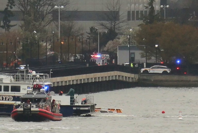 As seen from Pier 40 in New York, police and and fire crews from New York and New Jersey respond to the scene where a helicopter crashed into the Hudson River, Thursday, April 10, 2025