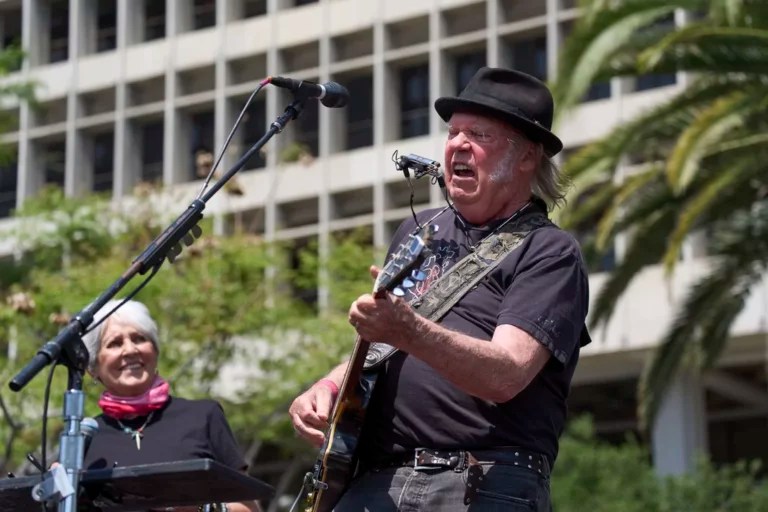 Neil Young performs alongside Joan Baez during a Fighting Oligarchy event with Sen. Bernie Sanders (I-VT) and Rep. Alexandria Ocasio-Cortez (D-NY) in Los Angeles, Saturday, April 12, 2025.