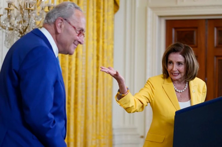 Former Speaker of the House Nancy Pelosi, D-Calif., looks to Senate Majority Leader Chuck Schumer, D-N.Y., as she speaks on the anniversary of the Inflation Reduction Act during an event in the East Room of the White House, Wednesday, Aug. 16, 2023, in Washington. (AP Photo/Evan Vucci)