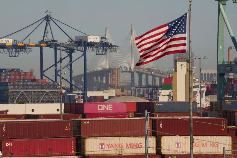 Containers with Yang Ming Marine Transport Corporation, a Taiwanese container shipping company, are stacked up at the Port of Los Angeles with the the Long Beach International Gateway Bridge seen in the background on Wednesday, April 9, 2025.