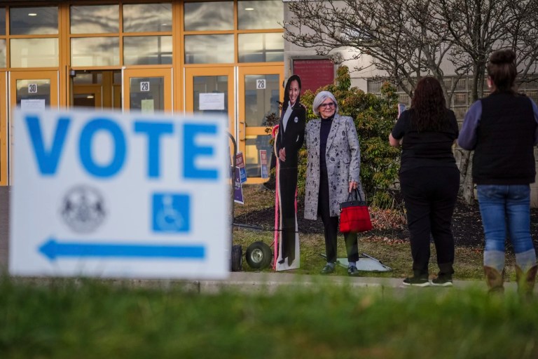 A voter poses for a cardboard cutout of Vice President Kamala Harris, Democratic presidential nominee, before voting opens at Scranton High School in Scranton, Pennsylvania, on Election Day, Tuesday, Nov. 5, 2024.