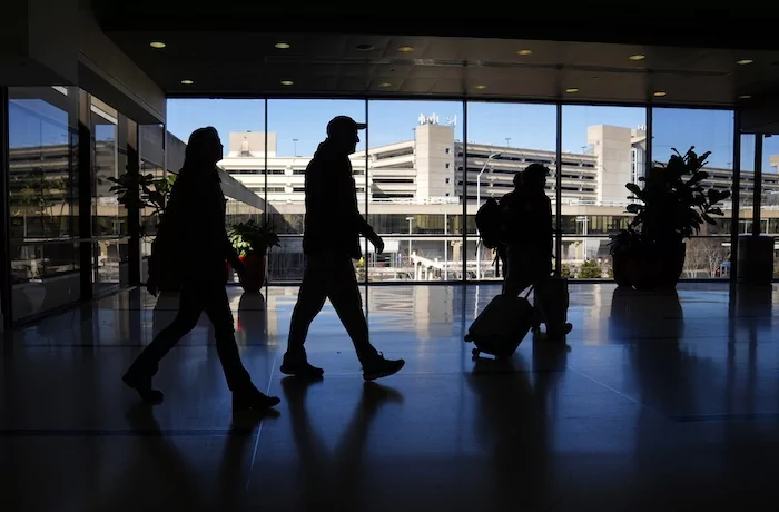 Travelers walk through Philadelphia International Airport in Philadelphia, Friday, Feb. 16, 2024. On Friday, March 15, 2024, the University of Michigan releases its preliminary reading of consumer sentiment for April.