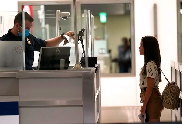 International passengers arrive at Miami international Airport where they are screened by U.S. Customs and Border Protection (CBP) using facial biometrics to automate manual document checks required for admission into the U.S. Friday, Nov. 20, 2020, in Miami. Miami International Airport is the latest airport to provide Simplified Arrival airport-wide. (AP Photo/Lynne Sladky)