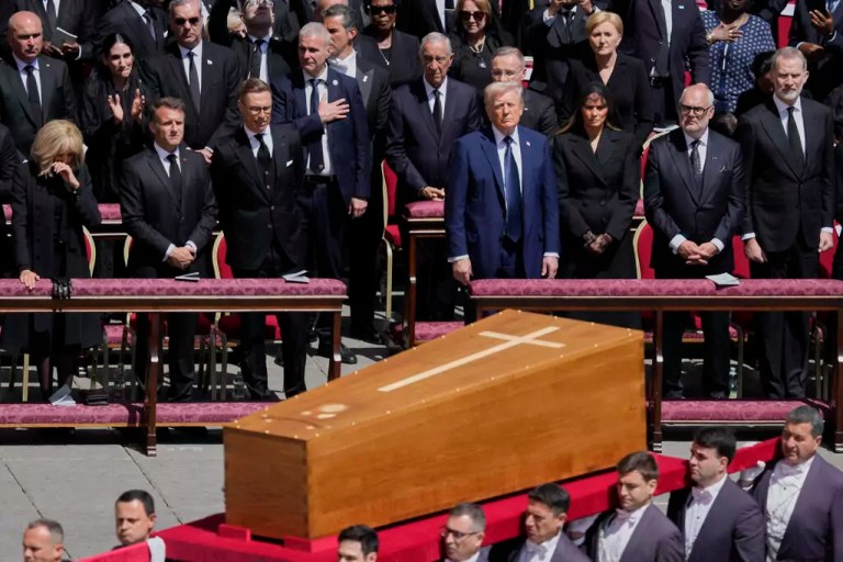 The coffin of Pope Francis is carried in front of dignitaries, including President Donald Trump, center, and French President Emmanuel Macron, during his funeral in St. Peter's Square at the Vatican, Saturday, April 26, 2025.
