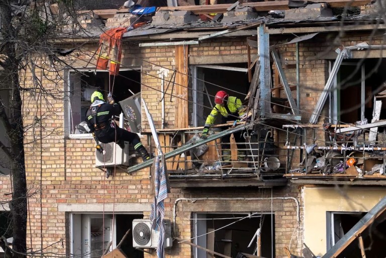 Rescue workers clear the rubble from a house heavily damaged after a Russian strike in a residential neighborhood in Kyiv, Ukraine, Thursday, April 24, 2025.