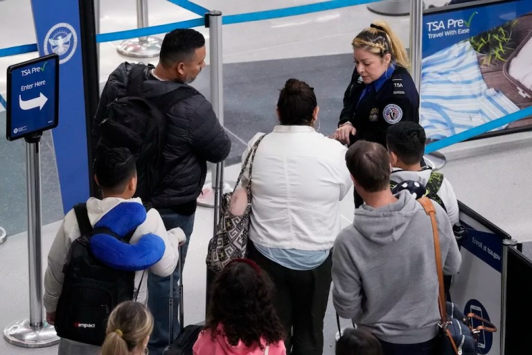Travelers wait to go through security check at O'Hare International Airport in Chicago