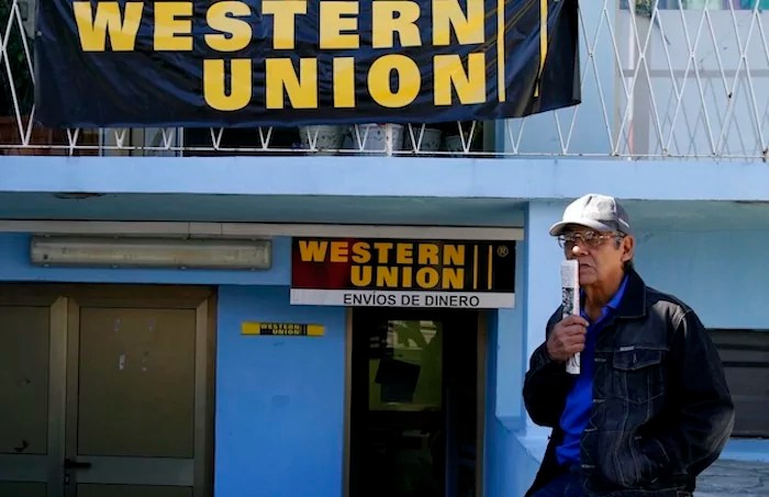 Claudio Calderon waits to receive money sent by his relatives in the US, from a Western Union agency in Havana, Cuba, Tuesday, Dec. 28, 2010. Cubans who rely on remittances from abroad are hailing a U.S. policy change that means they now can receive transfers in the island's convertible currency instead of dollars, sidestepping a 10 percent exchange surcharge. (AP Photo/Franklin Reyes)