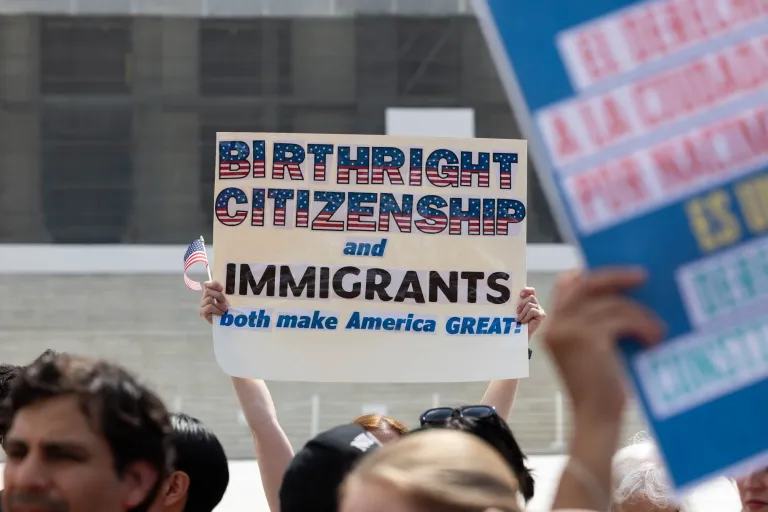 Protesters stand outside the Supreme Court, May 14, 2025, in protest of President Donald Trump's order to curtail birthright citizenship.
