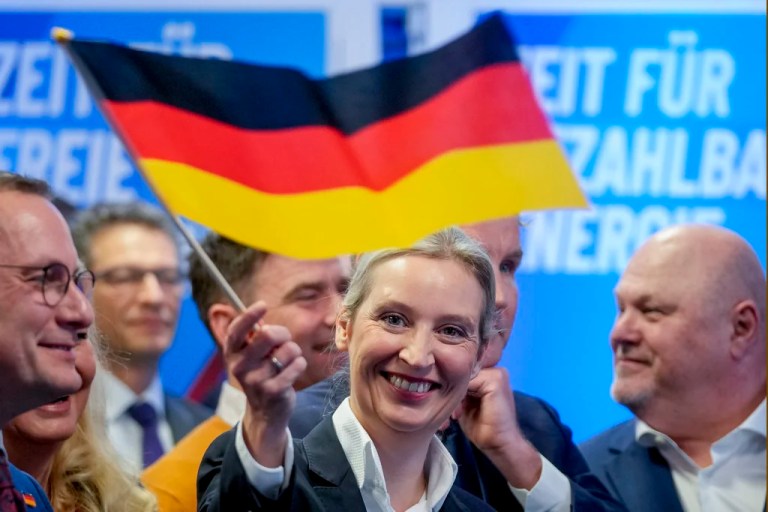 Leader of right-wing AfD Alice Weidel waves a German flag at the AfD party headquarters in Berlin, Germany, Sunday, Feb. 23, 2025, after the German national election.