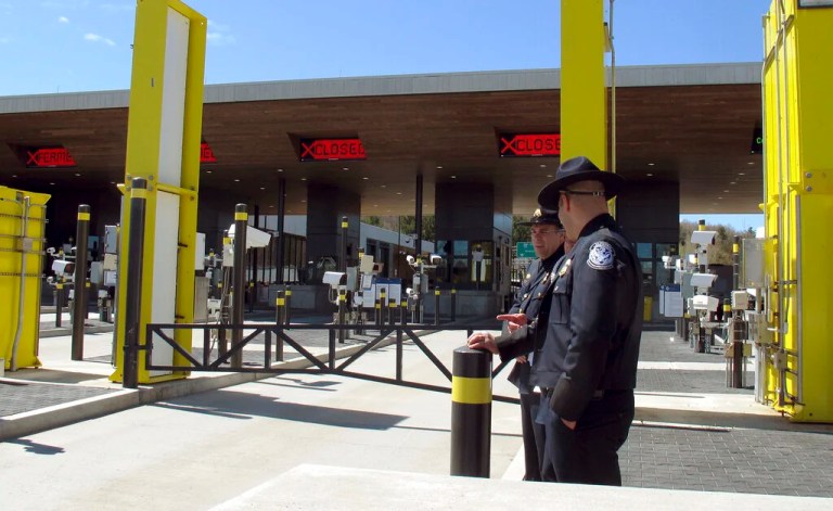 In this May 8, 2019 photo, U.S. Customs and Border Protection officials stand at the new border crossing facility on the U.S.-Canadian border in Derby Line, Vt. Court documents say federal agents seized almost 370 pounds (166.6 kilos) of cocaine that was hidden in a truck that was preparing to enter Canada at the Derby Line border crossing on Dec. 7. (AP Photo/Wilson Ring, File)