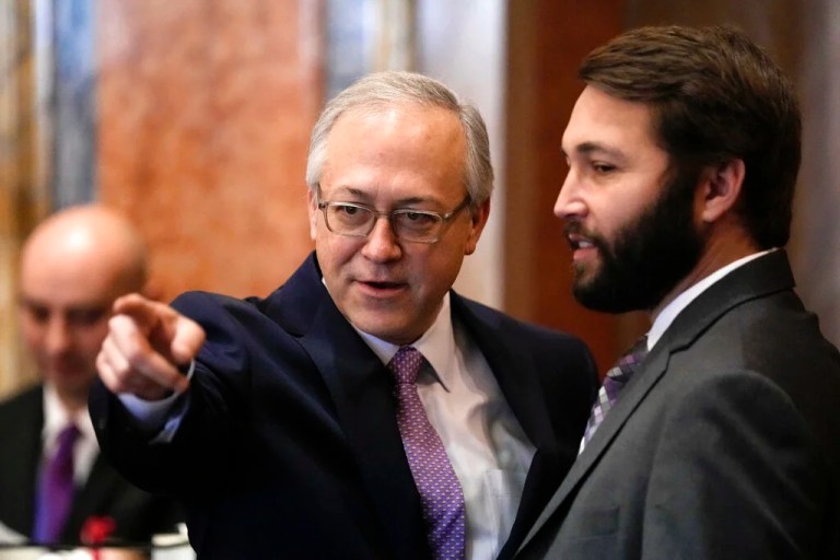 State Rep. David Young (R) talks with State Rep. Bobby Kaufmann (R), right, during the opening day of the Iowa Legislature, Monday, Jan. 9, 2023, in Des Moines, Iowa.