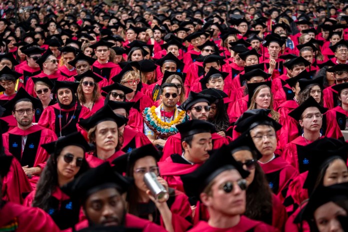 Students listen during commencement in Harvard Yard