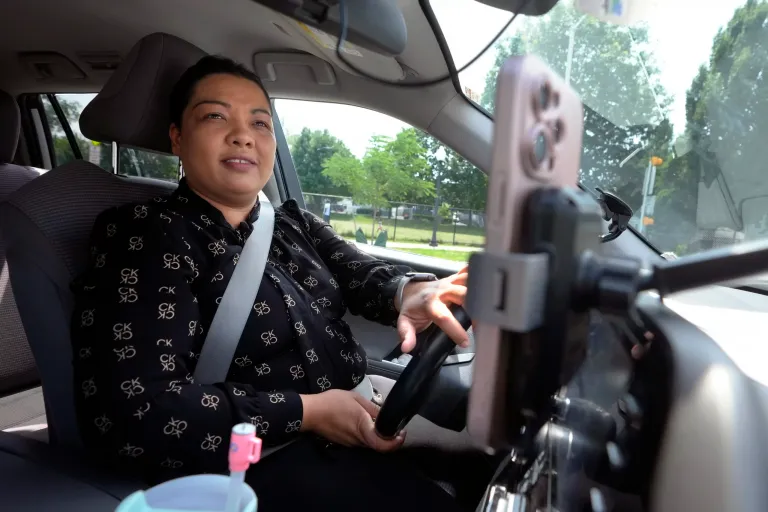 Yolanda Rodriguez, 33, of Malden, Massachusetts, drives her vehicle before going to work for a ride-hailing company, Tuesday, July 9, 2024.