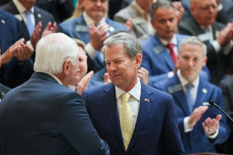Gov. Brian Kemp, facing, greets Republican state House Speaker Jon Burns during a press conference about the signing of numerous bills, including the student safety bill, House Bill 268, at the north wing steps of the Georgia State Capitol, Monday, April 28, 2025, in Atlanta.