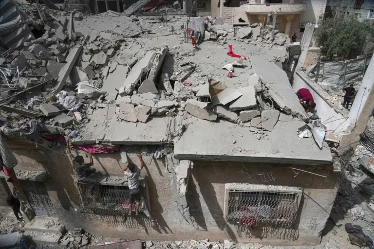 Palestinians inspect the house of the Jabr family after it was hit earlier by an Israeli army strike killing at least 10 people, in Jabalia, northern Gaza Strip, Sunday, May 18, 2025. (AP Photo/Jehad Alshrafi)