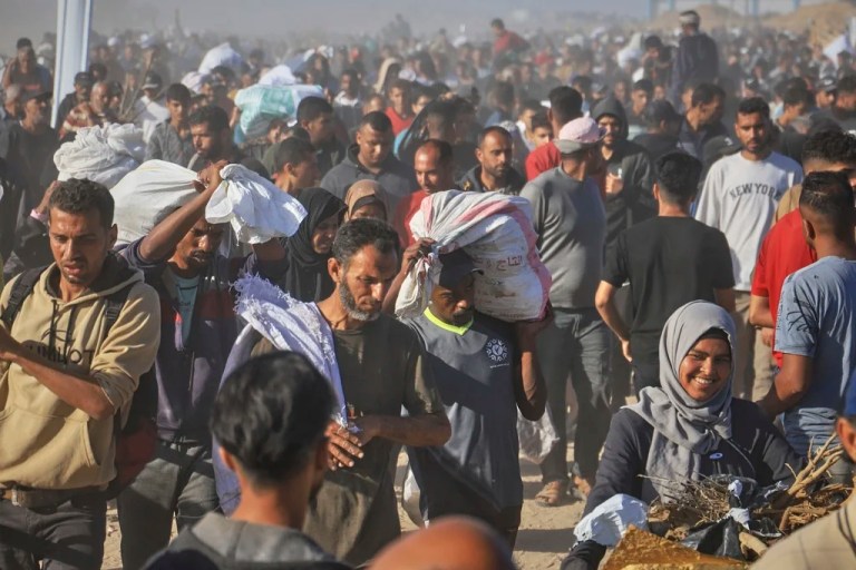 Palestinians carry boxes and bags containing food and humanitarian aid packages delivered by the Gaza Humanitarian Foundation, a U.S.-backed organization approved by Israel, in Rafah, southern Gaza Strip, Thursday, May 29, 2025.
