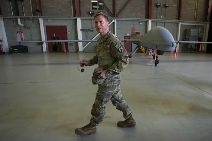Army Maj. Gen. Scott M. Naumann, military commander of the Joint Task Force Southern Border, walks past a drone in a hangar at Fort Huachuca Thursday, April 3, 2025, in Sierra Vista, Arizona.