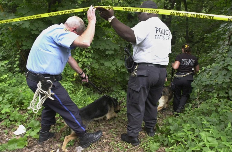 Philadelphia K-9 unit police walk into an area of Fairmount Park