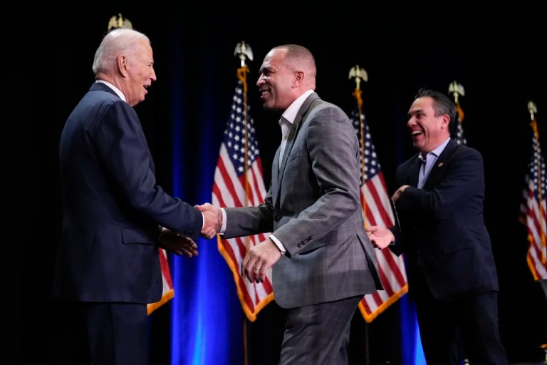 Former President Joe Biden steps on stage to speak to the House Democratic Caucus Issues Conference at Lansdowne Resort, greeted by House Minority Leader Hakeem Jeffries (D-NY), center, and Democratic Caucus Chairman Rep. Pete Aguilar (D-CA), right, Thursday, Feb. 8, 2024 In Leesburg, Virginia.