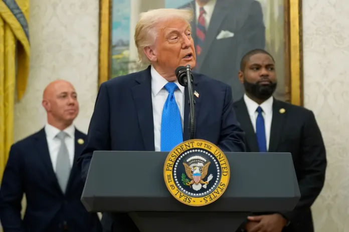 President Donald Trump speaks as Reps. Brian Mast (R-FL) and Byron Donalds (R-FL) listen.