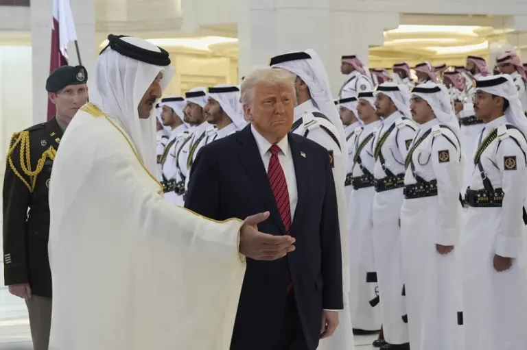 Qatar's Emir Sheikh Tamim bin Hamad Al Thani welcomes President Donald Trump during an official welcoming ceremony at the Amiri Diwan in Doha, Qatar, Wednesday, May 14, 2025.