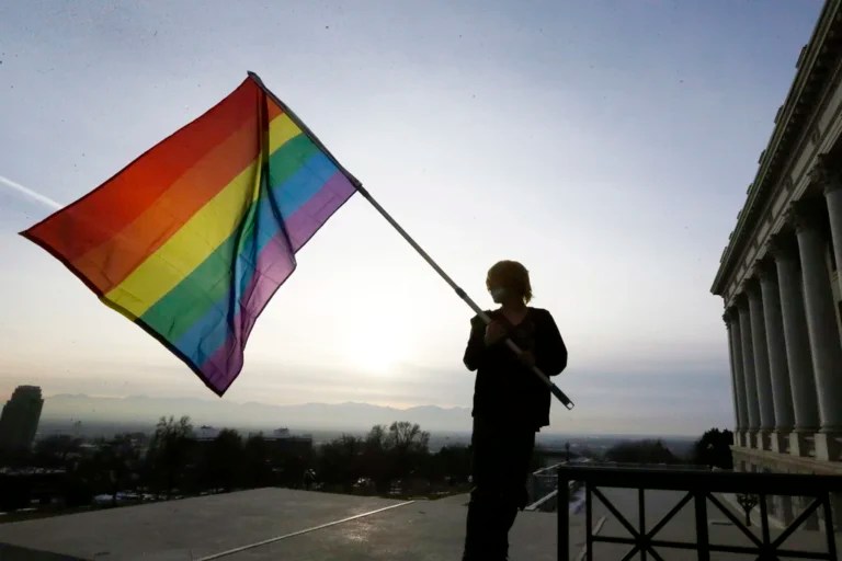 Corbin Aoyagi, a supporter of gay marriage, waves a rainbow flag during a rally at the Utah State Capitol on Jan. 28, 2014, in Salt Lake City. Utah teachers will be free to display LGBT pride flags and other social, political or religious imagery after the state House blocked a bill Monday, Feb. 26, 2024, that would have banned teachers from using their position to promote or disparage certain beliefs.