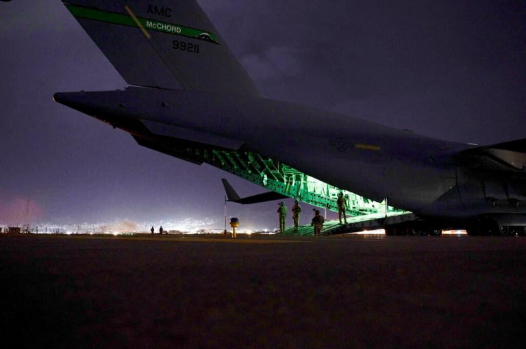 In this photo provided by the U.S. Air Force, an Air Force aircrew, assigned to the 816th Expeditionary Airlift Squadron, prepares to receive soldiers, assigned to the 82nd Airborne Division, to board a U.S. Air Force C-17 Globemaster III aircraft in support of the final noncombatant evacuation operation missions at Hamid Karzai International Airport in Kabul, Afghanistan on Aug. 30, 2021. The U.S. airlifted 124,000 people out of Kabul over about six weeks as the American-backed Afghan military and government fell to the Taliban.